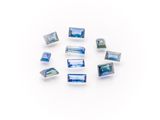 a group of blue and white glass beads sitting on top of a white surface