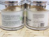 two jars of powder sitting on top of a wooden table