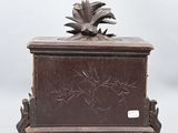 an old wooden box with a flower on top of it
