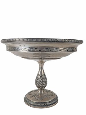 an image of a silver plate with a design on it