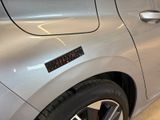 a close up of a silver car with a sticker on it