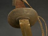 a close up of a wooden object with a metal object on top of it