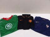 three soccer shirts are sitting on a table next to each other