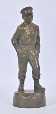 bronze figurine of a man in uniform standing on a base