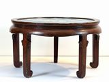 a wooden table with a marble top on a white surface