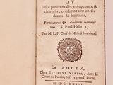 an old book that is open on a table