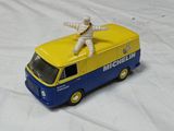 a toy van with a man sitting on top of it
