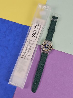 a watch that is laying on a colorful surface