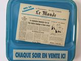 a blue tray with a newspaper and a newspaper on it
