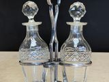 three glass decanters sitting on a wooden table