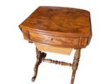 a small wooden table with a drawer on top of it