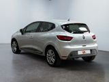 the rear end of a silver car in a white room