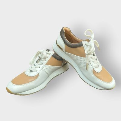 pair of women ' s white and beige sneakers on a white background