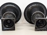 two black vases that are on a table