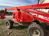 a red crane that is sitting in the grass