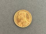 a gold coin with a portrait of a man on it