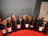 several bottles of wine are lined up in a row on a table