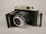 a black and white photo of an old camera on a table