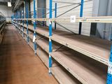 many shelves in the warehouse with empty shelves