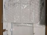 a large white bag sitting on top of a stack of boxes