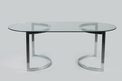 an image of a glass table with chrome legs and a glass top