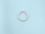 a close up of a silver ring on a blue surface