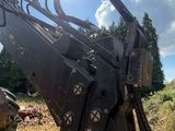 a large excavator that is sitting in the grass