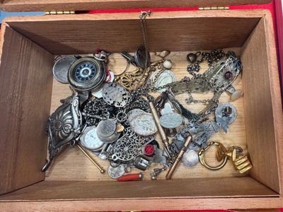 a wooden box filled with assorted items on a table