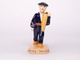 a figurine of a man holding a piece of bread