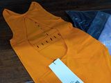 three shirts that are sitting on the floor next to each other