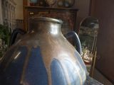 a large blue vase sitting on a table in a room