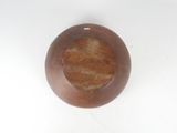a wooden bowl on a white surface with a white background
