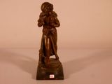 bronze statue of a woman holding a child on a marble base