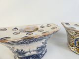 pair of blue and white ceramic vases with designs on them