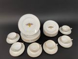 an image of a group of white dishes and cups on a table