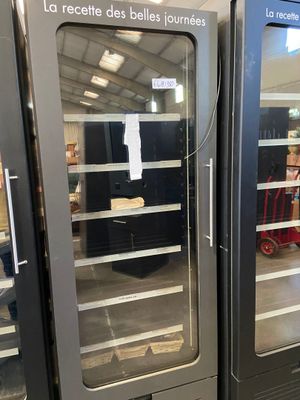 two refrigerators that are open in a store