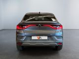 the rear end of a grey car in a white room