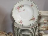 a lot of plates and bowls on the table