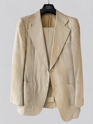 an image of a beige jacket hanging on a hanger