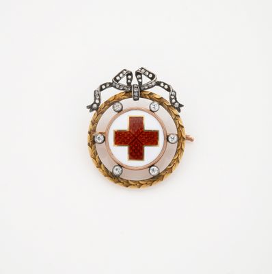une image représentant une broche en forme de croix rouge sur fond blanc