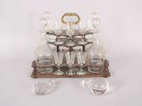 bottles and glasses on a stand on a white surface