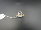 une image représentant une bague sertie d'une pierre bleue et d'une étiquette