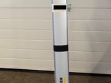 a yellow and black mop sitting on the floor in front of a garage door