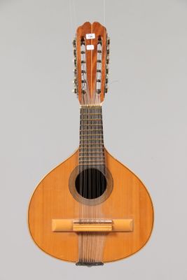 a guitar hanging from a string on a wall