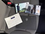 a picture of a car seat with a ticket and a laptop on it