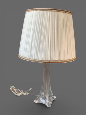 a close up of a lamp on a table with a white shade