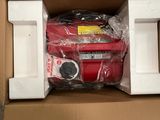 a cardboard box with a red suitcase inside of it