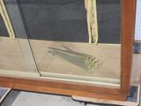 a glass case with a pair of scissors on top of it