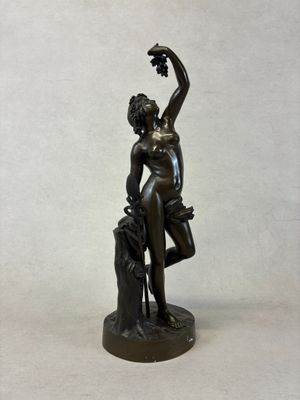 bronze statue of a woman holding a flower in her right hand