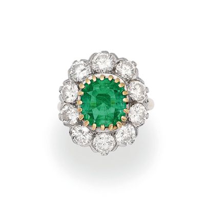 an emerald and diamond cluster ring
